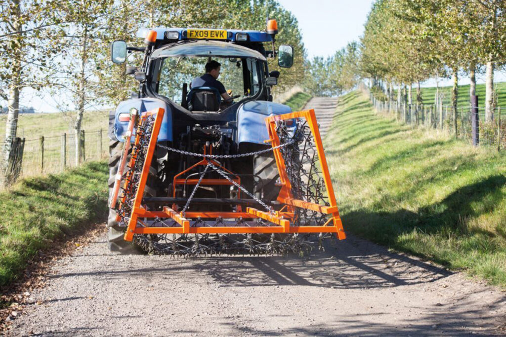 Tractor with levelling equipment on country lans